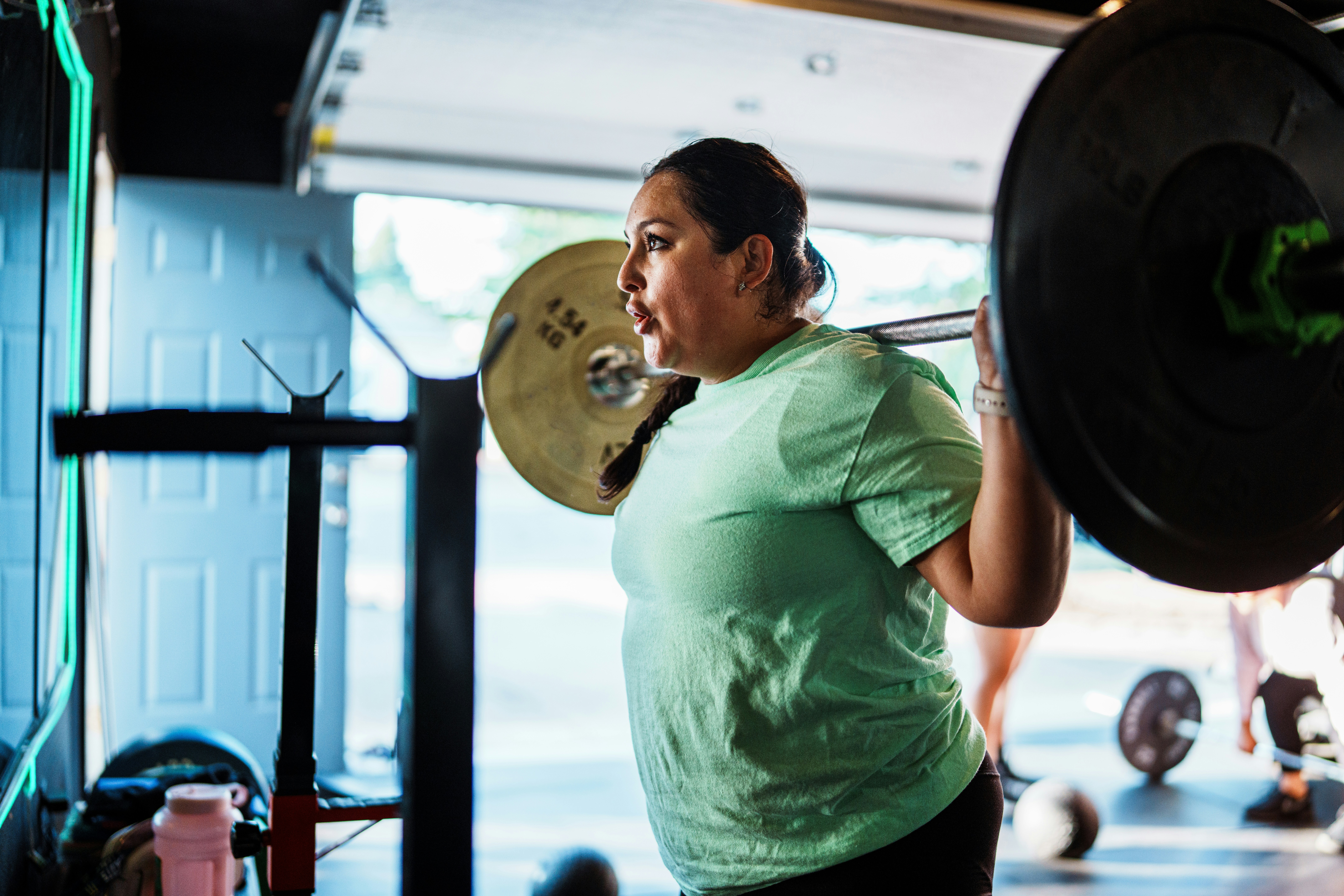 Active woman lifting weights at the gym
